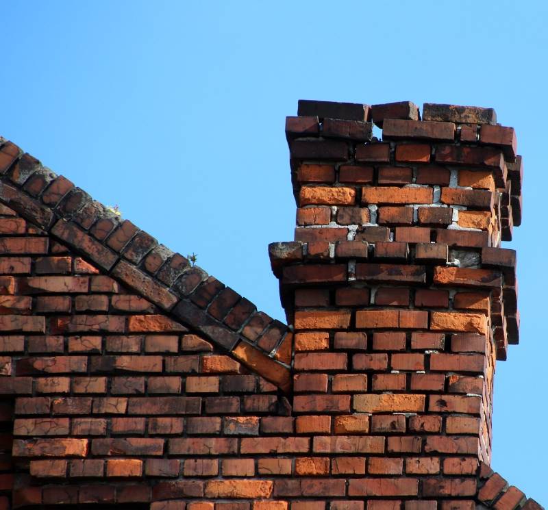 Signs Your Shirley Home Needs a Chimney Inspection Damaged chimney on an Shirley home showing cracks and missing mortar